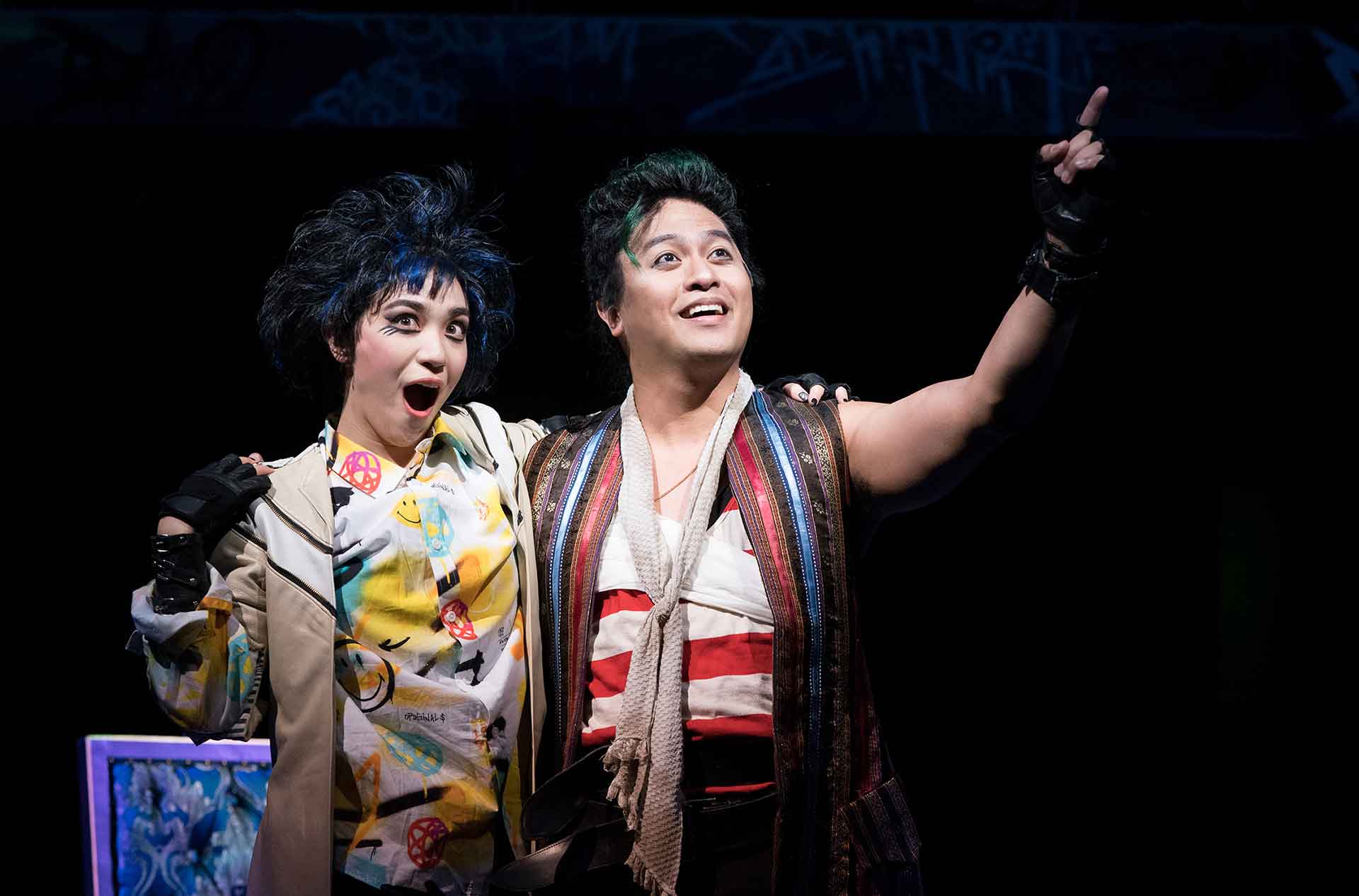 Two people smiling and looking out into the distance.