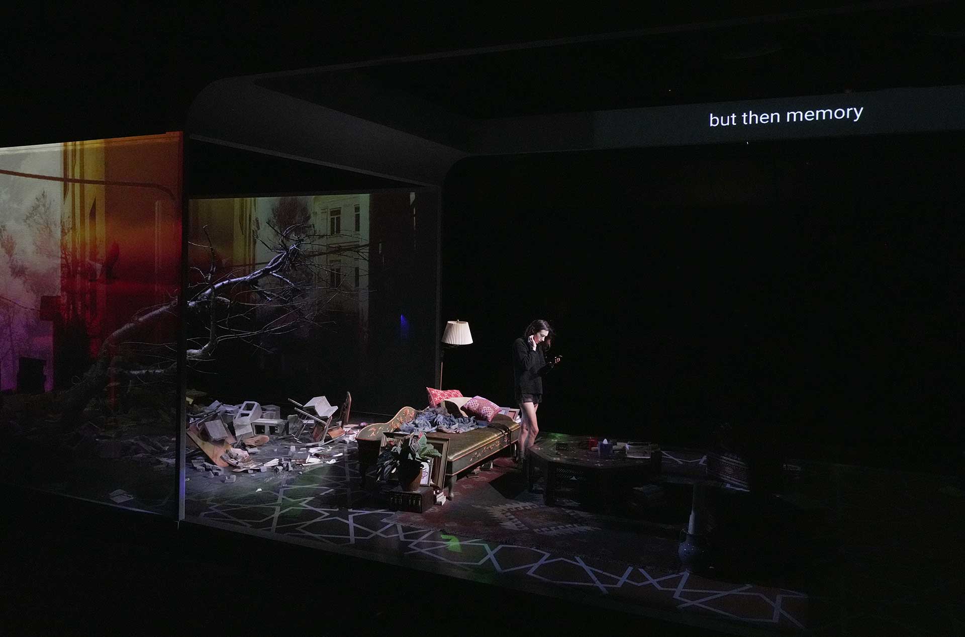 A person on stage with rubble.