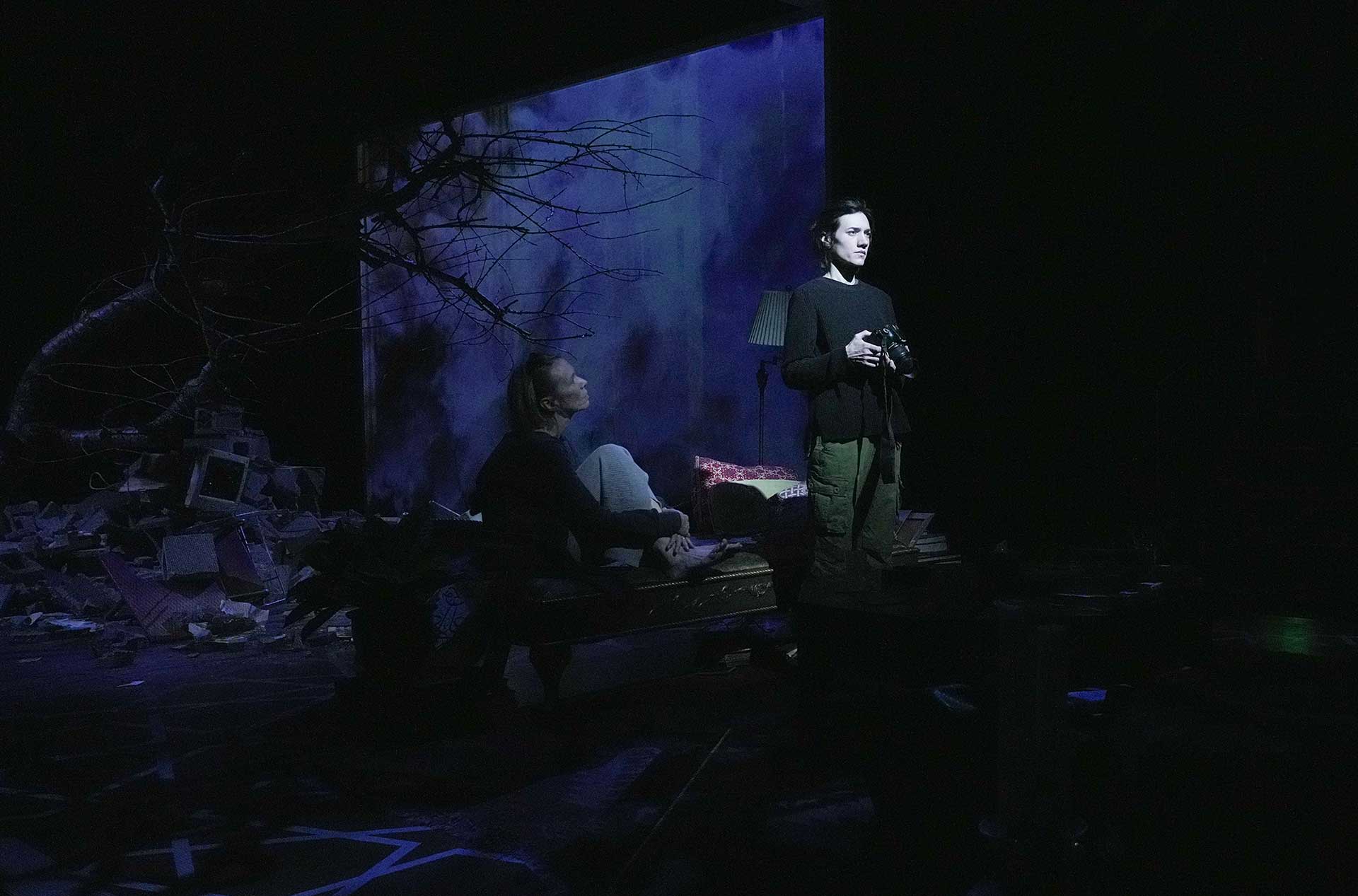 A photographer standing looking out into the distance.