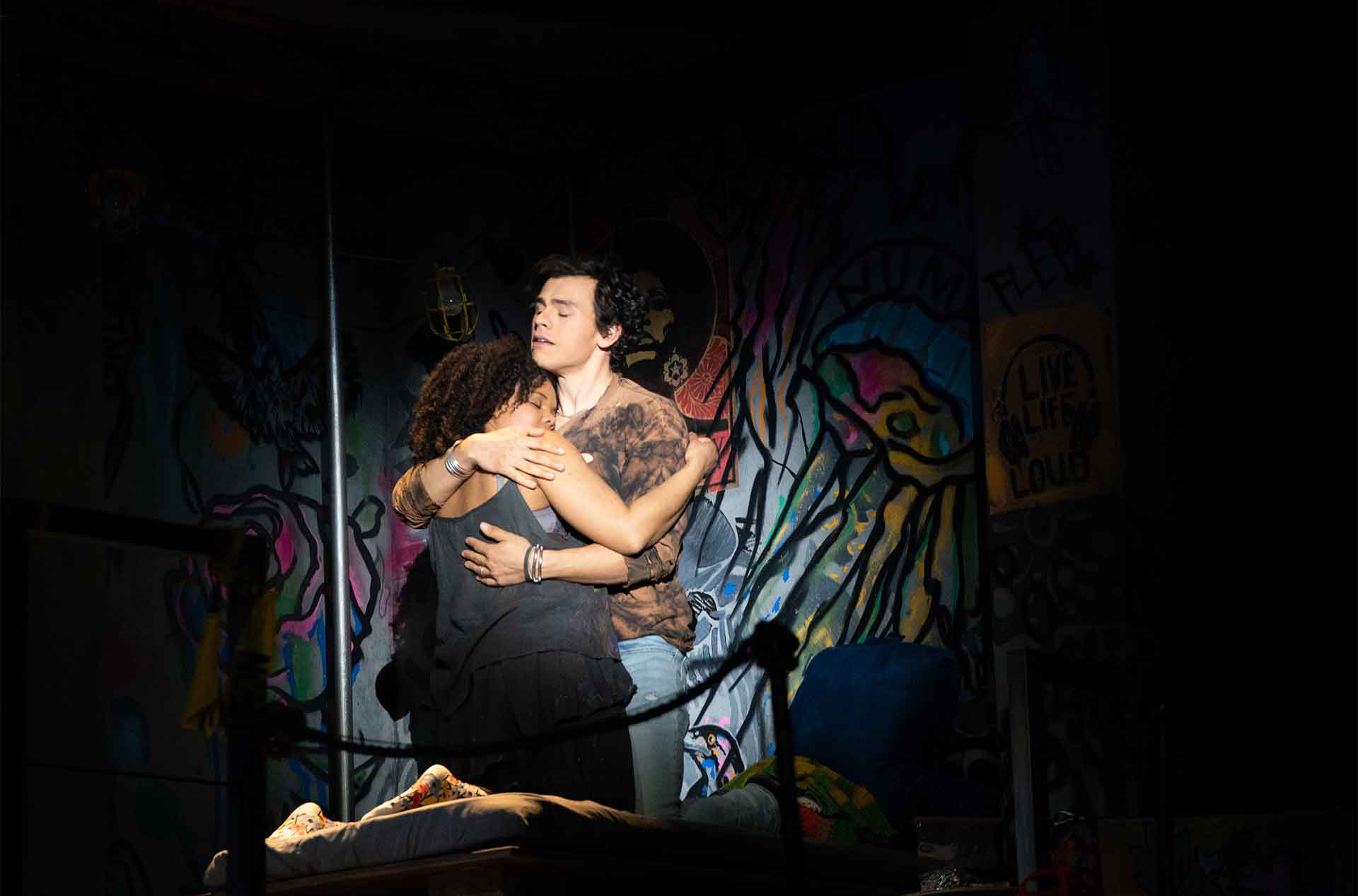 Romeo and Juliet holding each other.