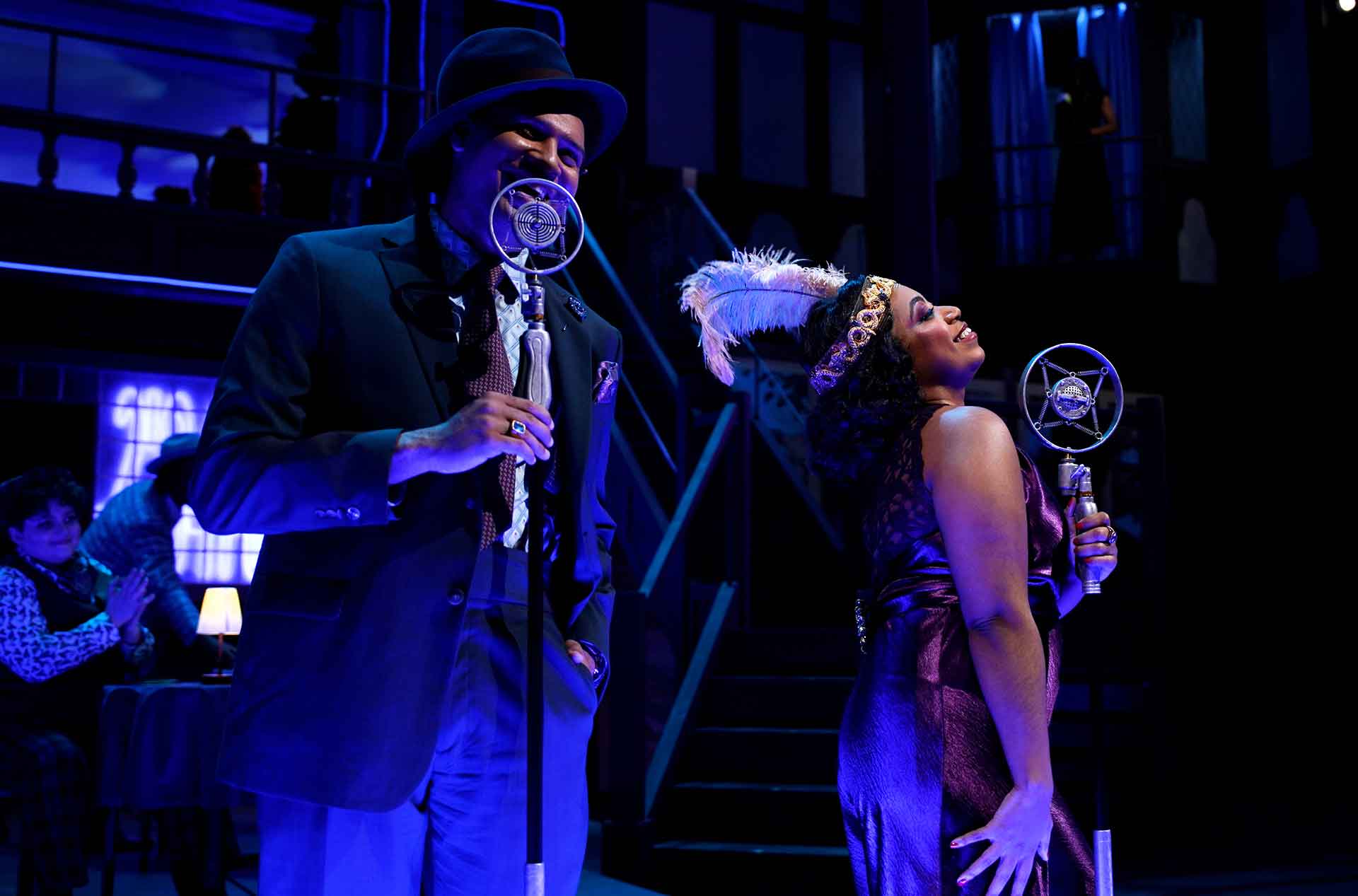 Two people singing into microphones.