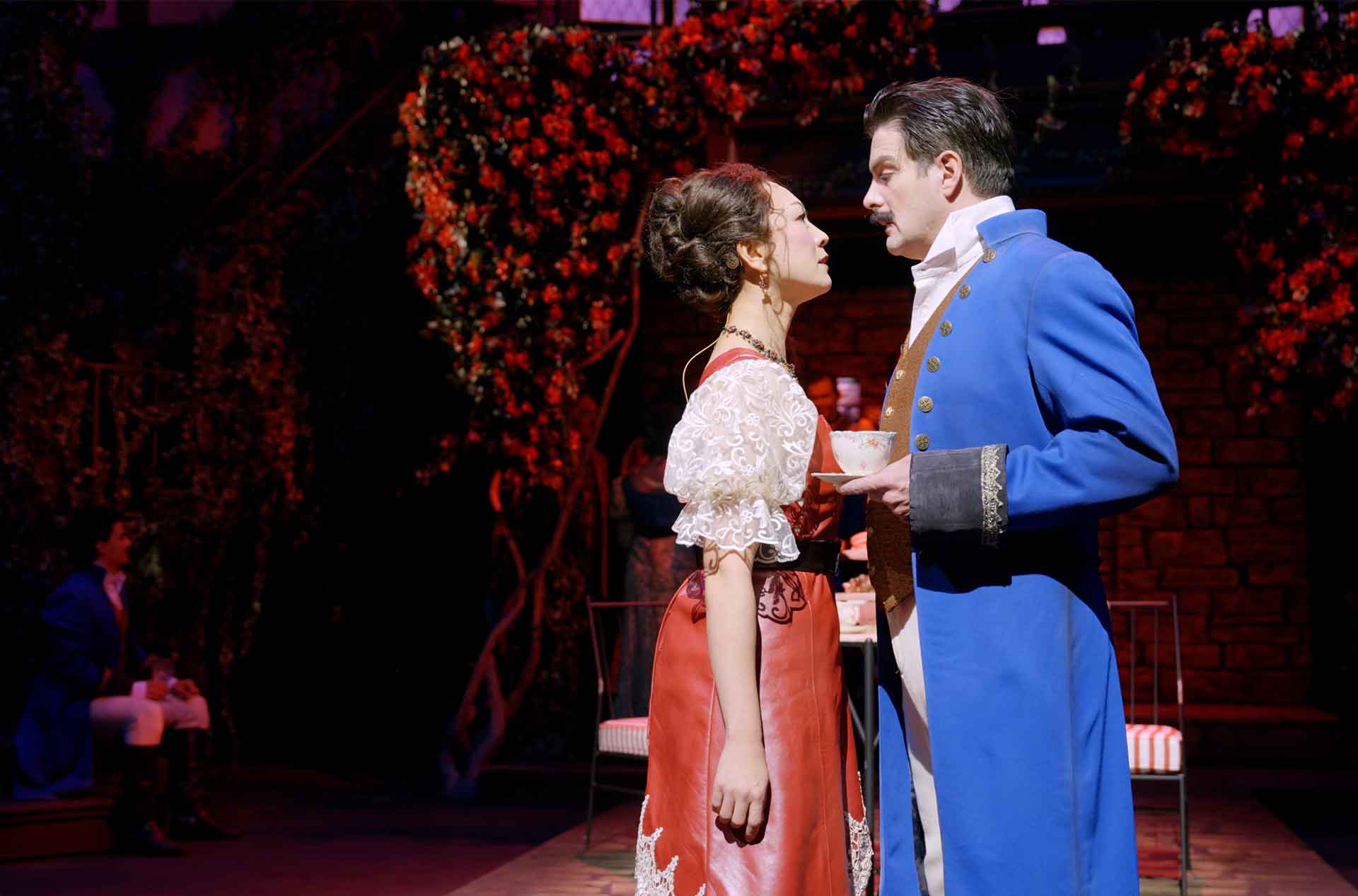 Two people standing looking each other in the eyes.