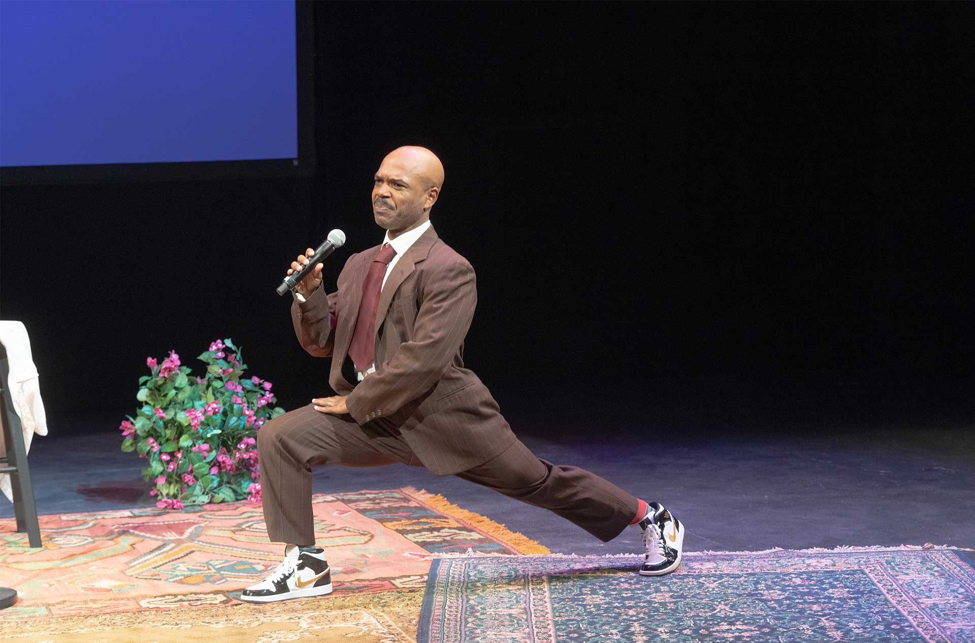 A person lunging holding a microphone.