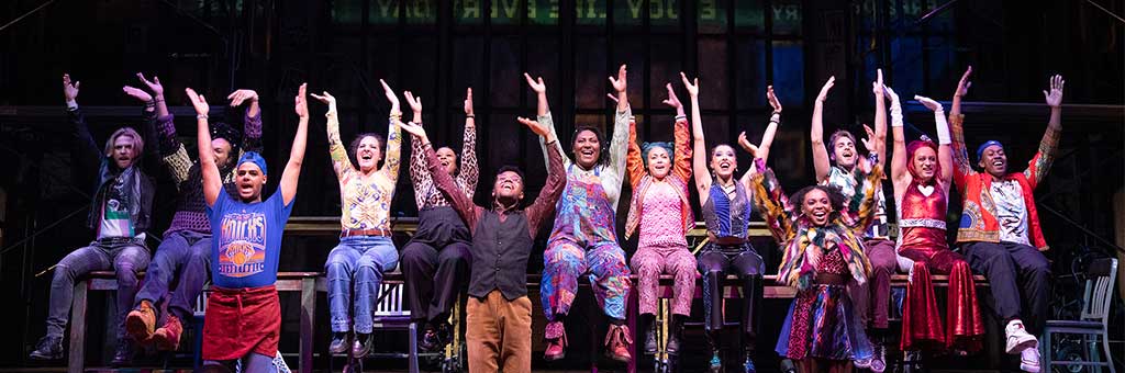 A group of people with their hands in the air.