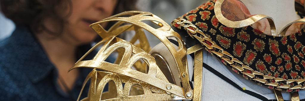 Close up of a gold shoulder costume piece.
