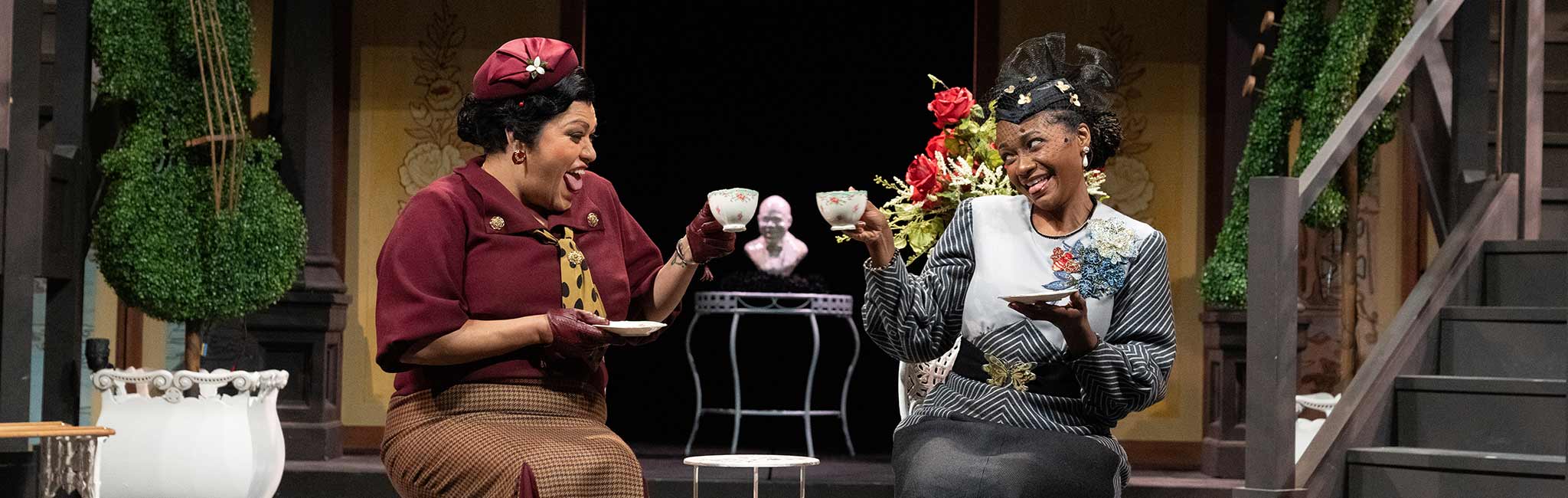 Two people enjoying tea at a table.