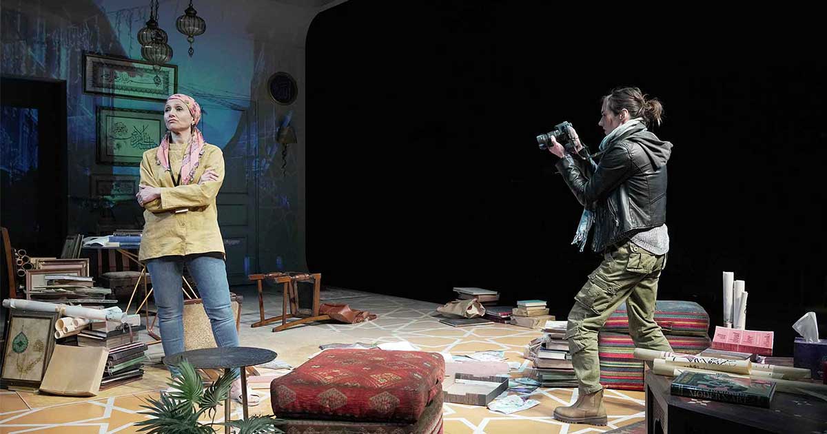 A person taking a photo of another person.