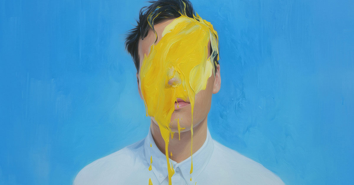 A person in a white shirt stands with their face obscured by a dramatic splash of yellow paint against a smooth blue background.